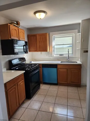 a kitchen with a stove top oven sink and cabinets