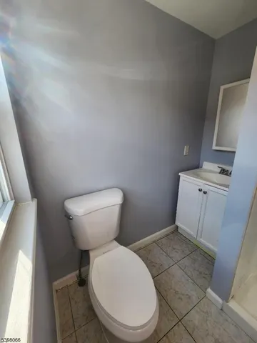 a white toilet sitting next to a sink and vanity