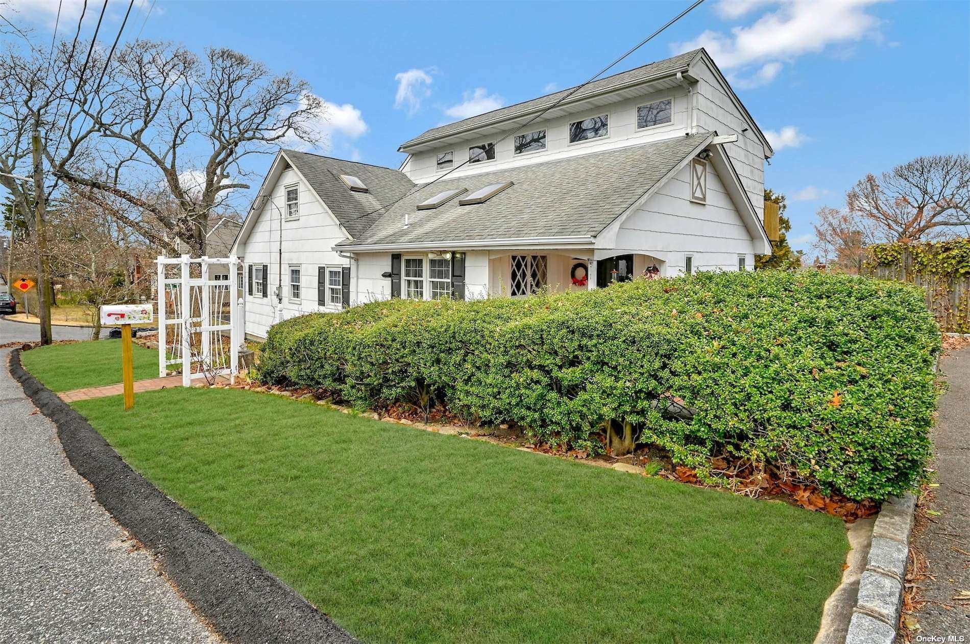 1 Tarn Road Rocky Point, NY 11778 - Photo 1 of 1 a front view of a house with a garden