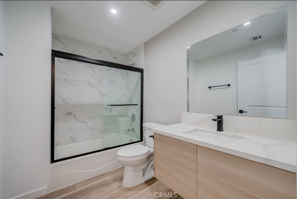 7018 Alabama Avenue, Unit 201 Canoga Park, CA 91303 - Photo 11 of 25 a bathroom with a sink toilet and shower
