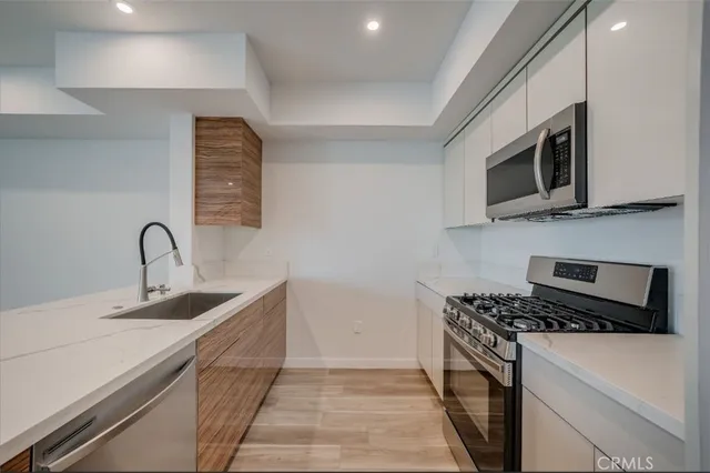 a spacious bathroom with a bathtub shower sink mirror and toilet