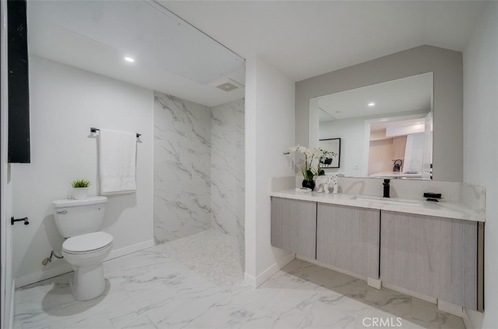 7018 Alabama Avenue, Unit 201 Canoga Park, CA 91303 - Photo 15 of 25 a bathroom with a sink a toilet and shower
