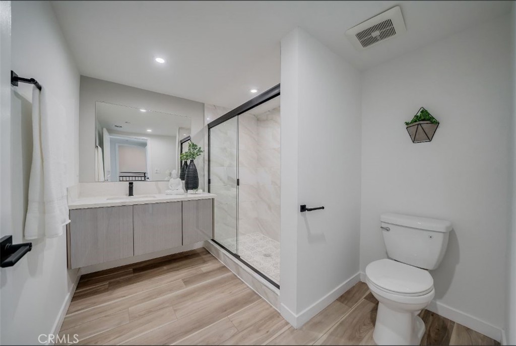 7018 Alabama Avenue, Unit 201 Canoga Park, CA 91303 - Photo 16 of 25 a bathroom with a sink toilet and shower
