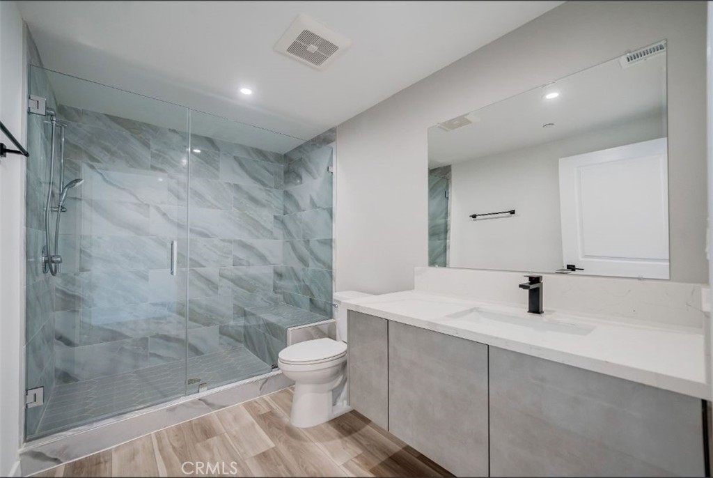 7018 Alabama Avenue, Unit 201 Canoga Park, CA 91303 - Photo 17 of 25 a bathroom with a sink a toilet and shower