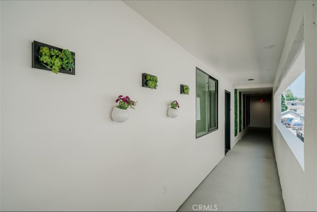7018 Alabama Avenue, Unit 201 Canoga Park, CA 91303 - Photo 18 of 25 a hallway with table and stairs