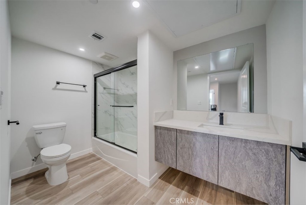 7018 Alabama Avenue, Unit 201 Canoga Park, CA 91303 - Photo 20 of 25 a bathroom with a sink a toilet and shower