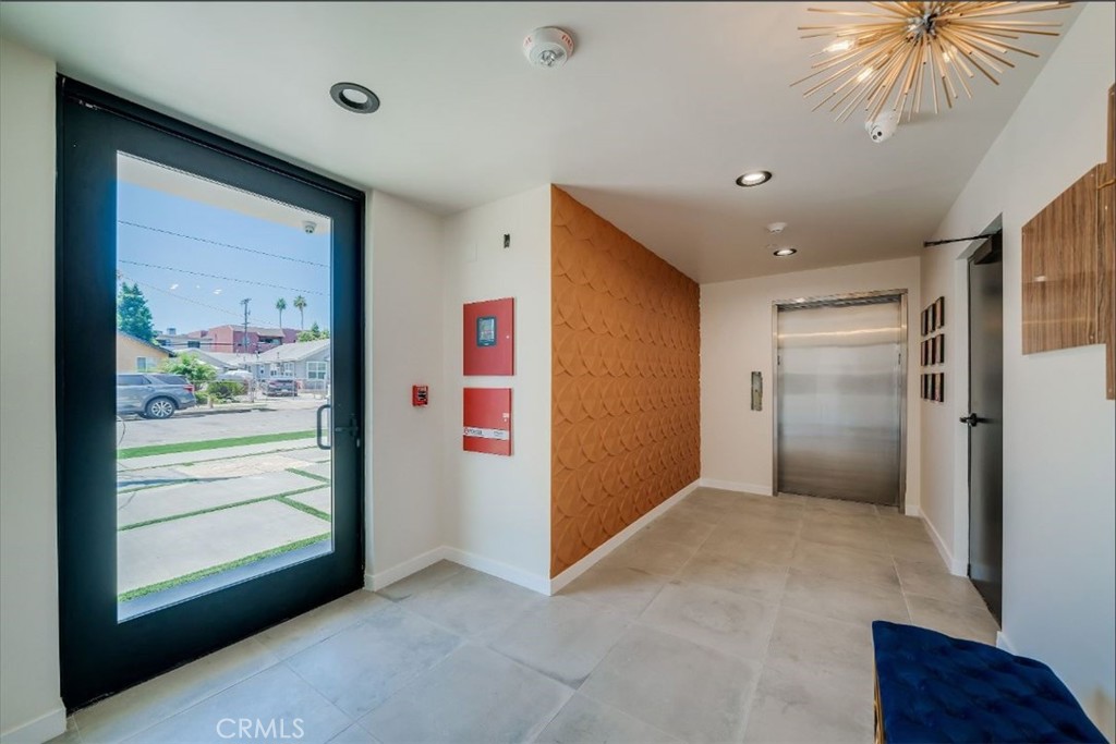 7018 Alabama Avenue, Unit 201 Canoga Park, CA 91303 - Photo 2 of 25 a view of hallway with a ceiling fan and a large window