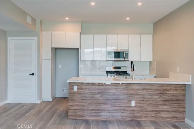a kitchen with stainless steel appliances a refrigerator stove and sink