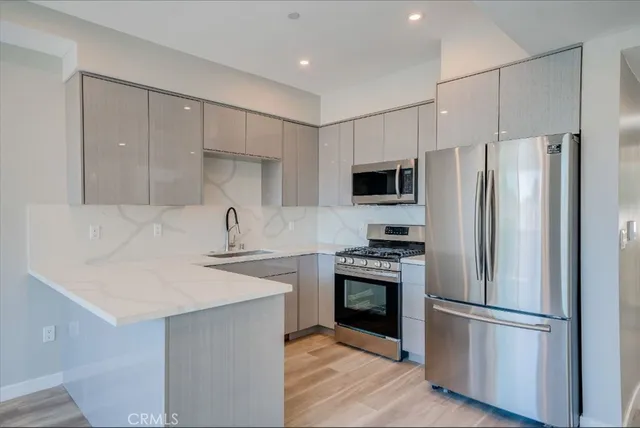a bathroom with a granite countertop sink a toilet and shower