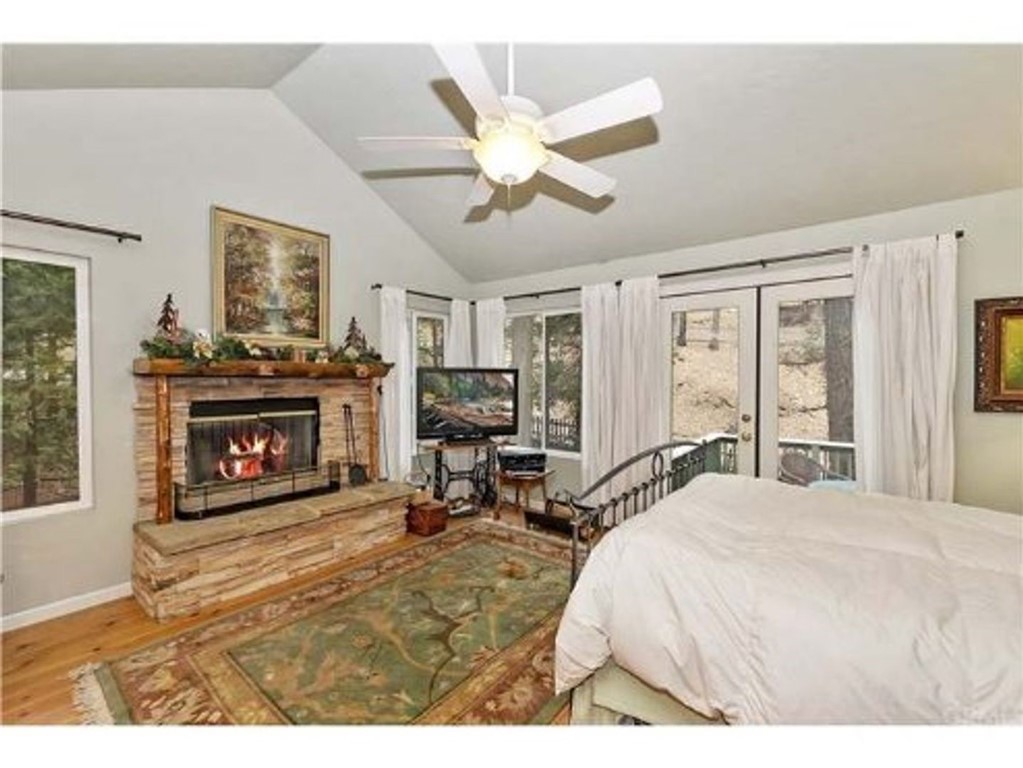 29591 Hook Creek Road Cedar Glen, CA 92321 - Photo 6 of 14 a bed room with a bed and a fireplace