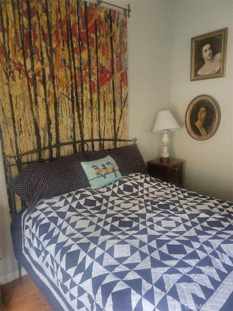 29591 Hook Creek Road Cedar Glen, CA 92321 - Photo 9 of 14 a large bed sitting in a bedroom next to a lamp and a lamp