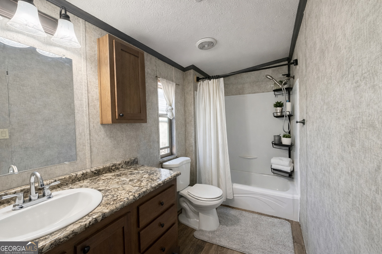 195 Margarets Grove Road Crawfordville, GA 30631 - Photo 11 of 34 a bathroom with a granite countertop sink toilet and shower