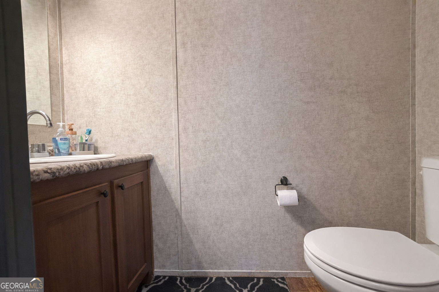 195 Margarets Grove Road Crawfordville, GA 30631 - Photo 13 of 34 a bathroom with a granite countertop toilet and a sink