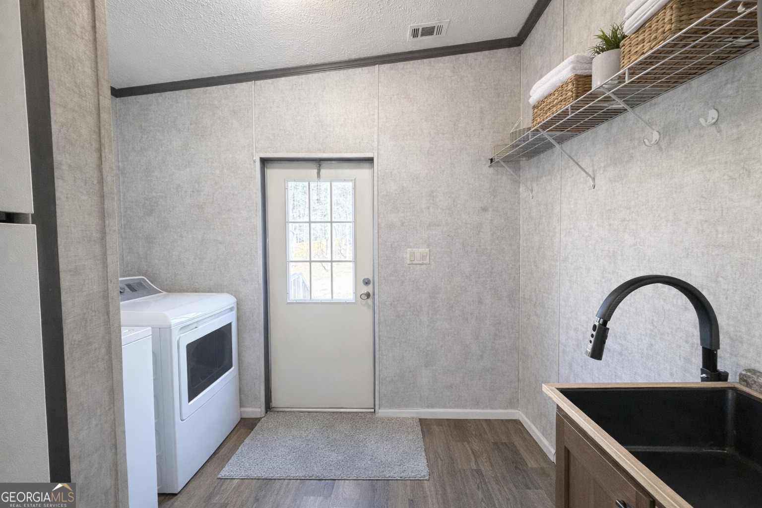 195 Margarets Grove Road Crawfordville, GA 30631 - Photo 14 of 34 a close view of a sink a microwave and cabinets in a room