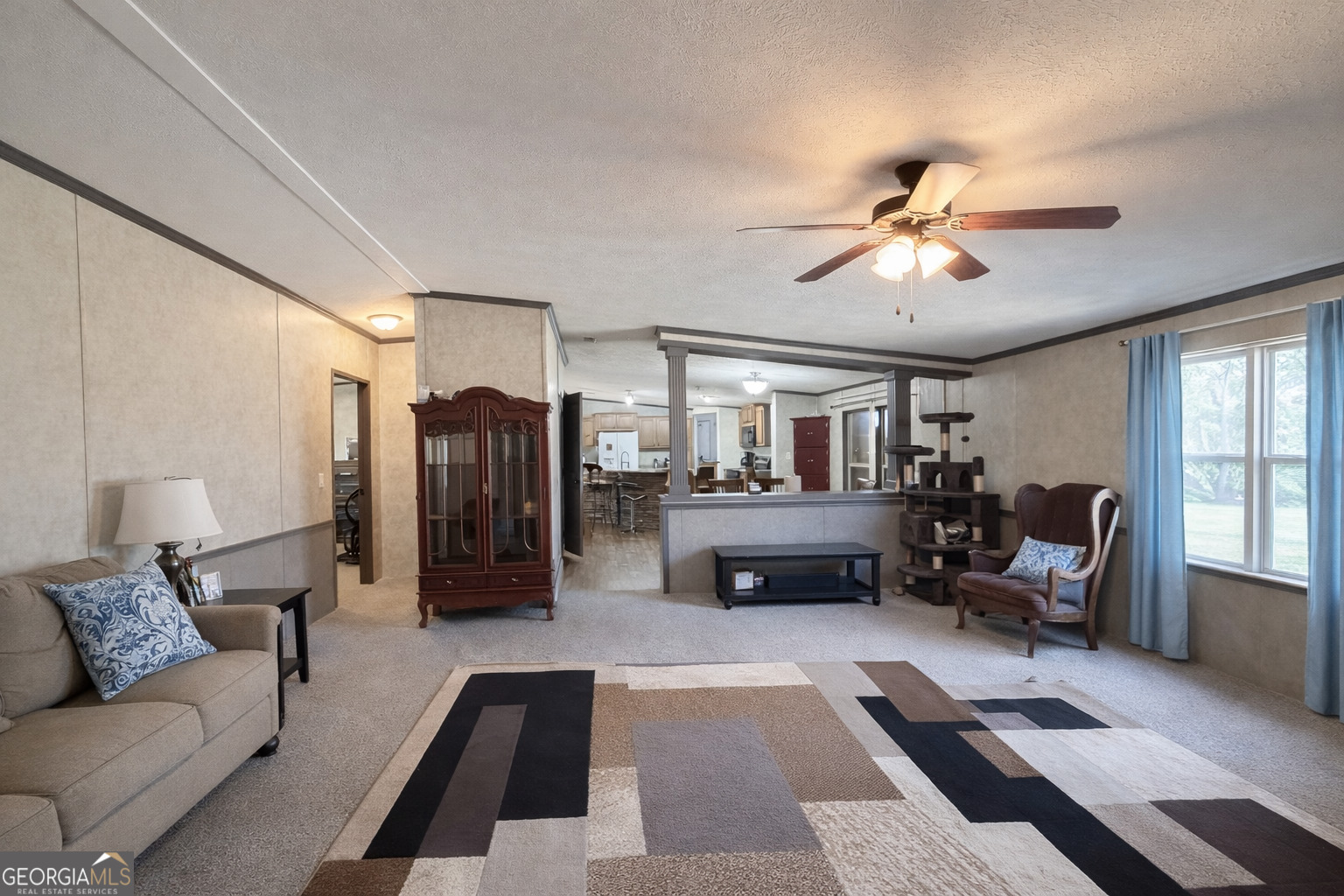 195 Margarets Grove Road Crawfordville, GA 30631 - Photo 2 of 34 a living room with furniture and a chandelier