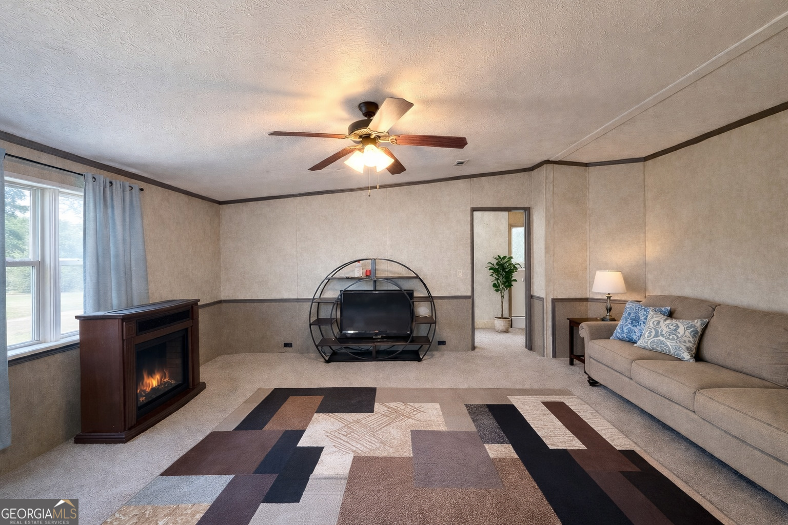 195 Margarets Grove Road Crawfordville, GA 30631 - Photo 3 of 34 a living room with furniture and a fireplace