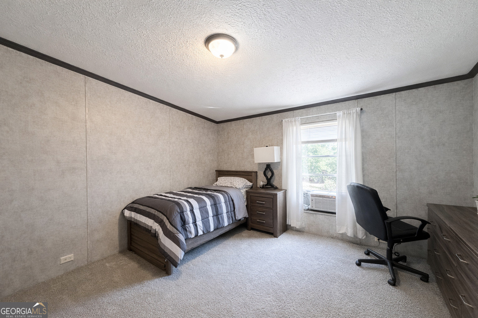 195 Margarets Grove Road Crawfordville, GA 30631 - Photo 7 of 34 a room with a bed and a chair