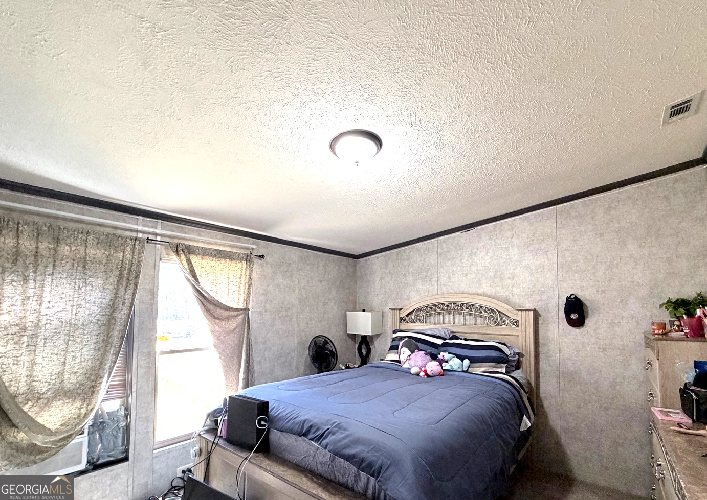 195 Margarets Grove Road Crawfordville, GA 30631 - Photo 8 of 34 a bedroom with a bed and a window with the outer view