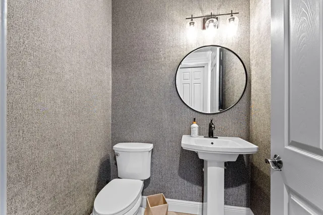 a bedroom with a bed a table and windows