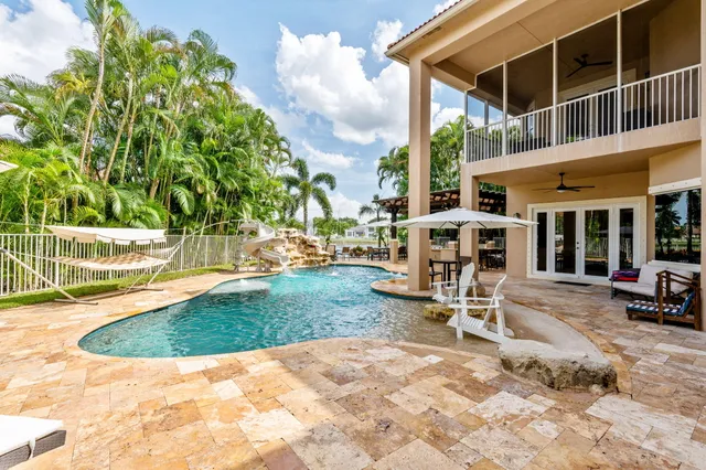 an aerial view of a house with a yard and potted plants