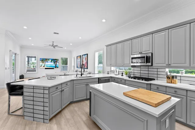a kitchen with stainless steel appliances a refrigerator sink and cabinets