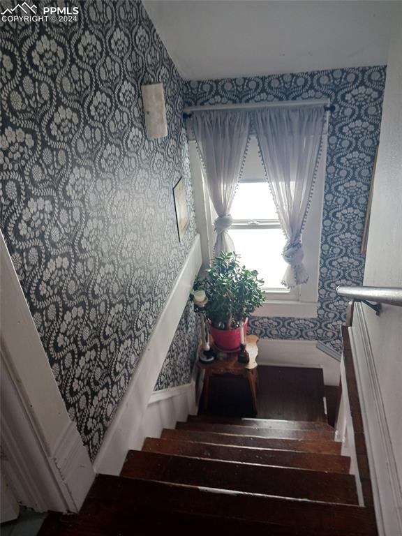 209 Indiana Avenue Walsenburg, CO 81089 - Photo 22 of 37 a living room with a couch and a chandelier