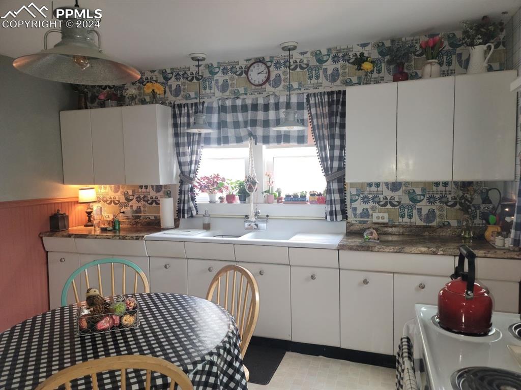 209 Indiana Avenue Walsenburg, CO 81089 - Photo 10 of 37 a kitchen with a sink cabinets and window
