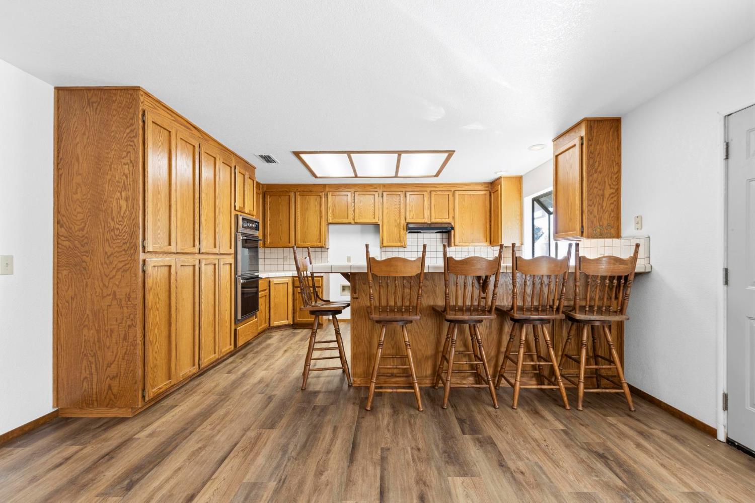 8711 Fruchtenicht Road Knights Landing, CA 95645 - Photo 24 of 44 a dining room with furniture window and wooden floor