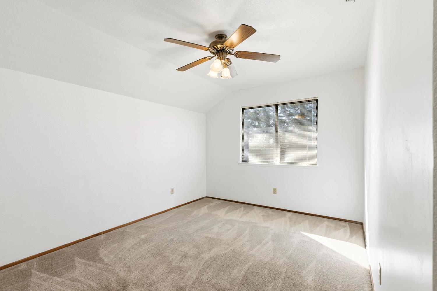 8711 Fruchtenicht Road Knights Landing, CA 95645 - Photo 27 of 44 an empty room with a window and a ceiling fan