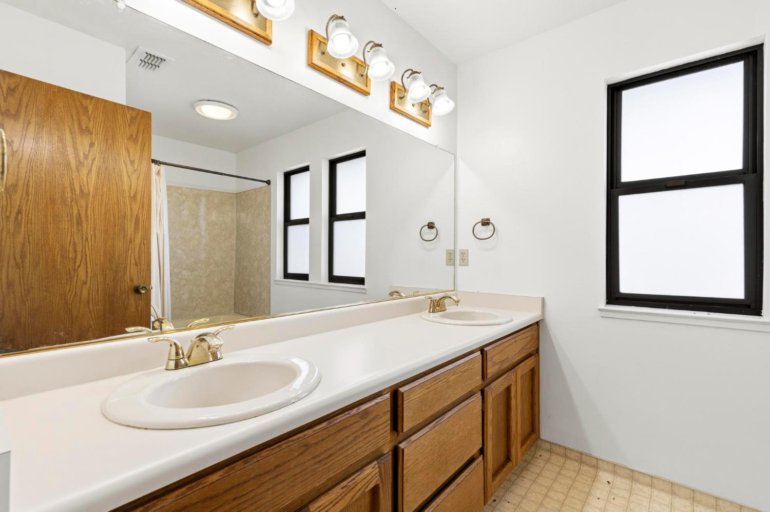 8711 Fruchtenicht Road Knights Landing, CA 95645 - Photo 30 of 44 a bathroom with a granite countertop sink mirror and a