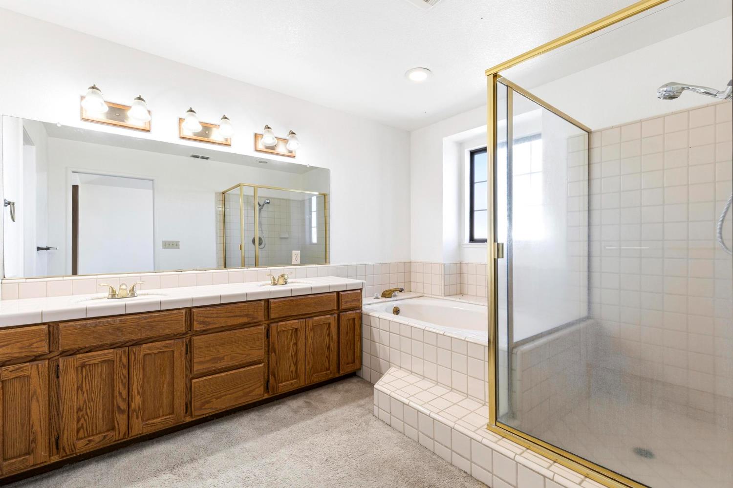 8711 Fruchtenicht Road Knights Landing, CA 95645 - Photo 34 of 44 a spacious bathroom with a tub sink shower and mirror