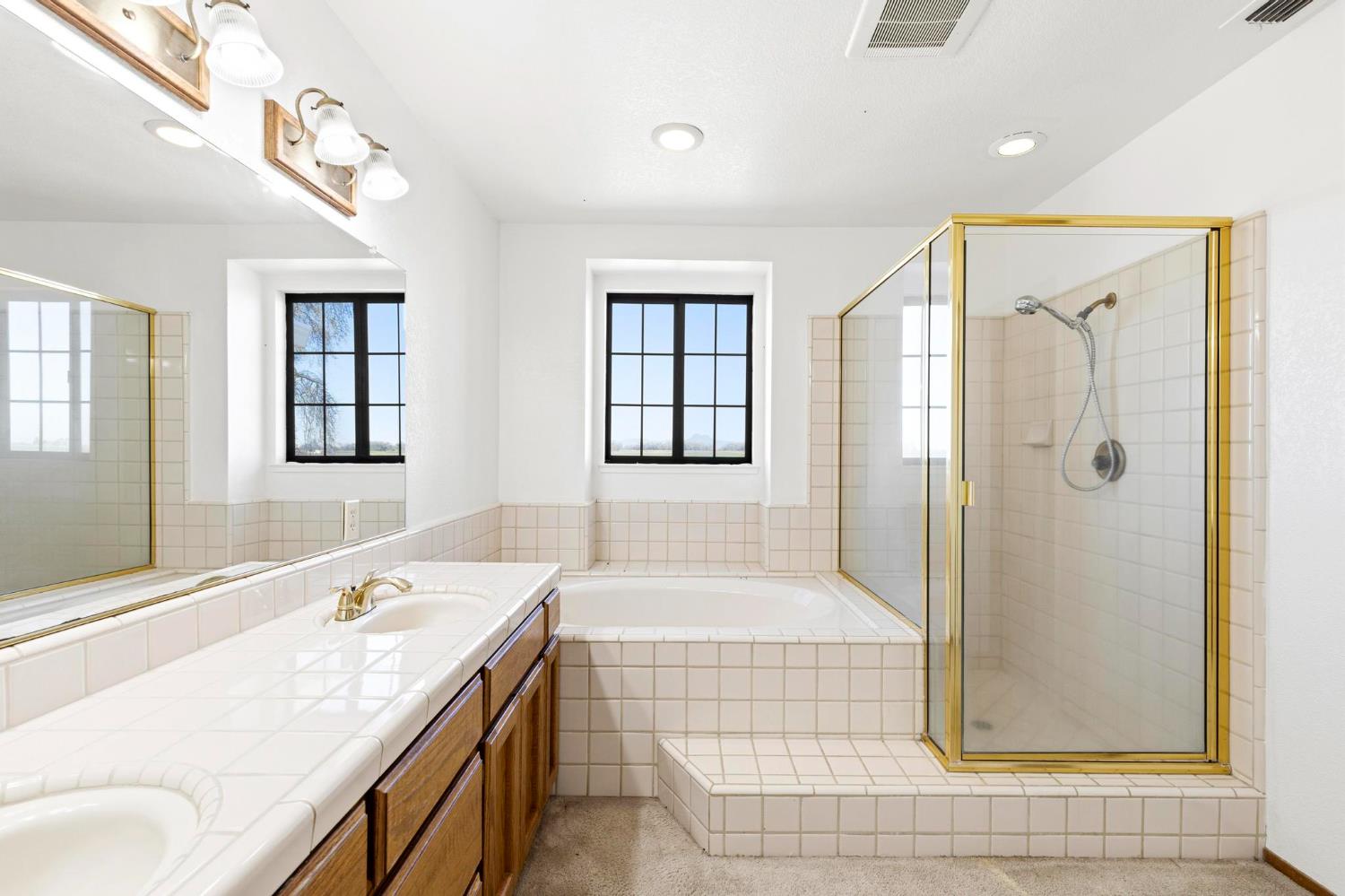 8711 Fruchtenicht Road Knights Landing, CA 95645 - Photo 35 of 44 a bathroom with a granite countertop tub sink and shower