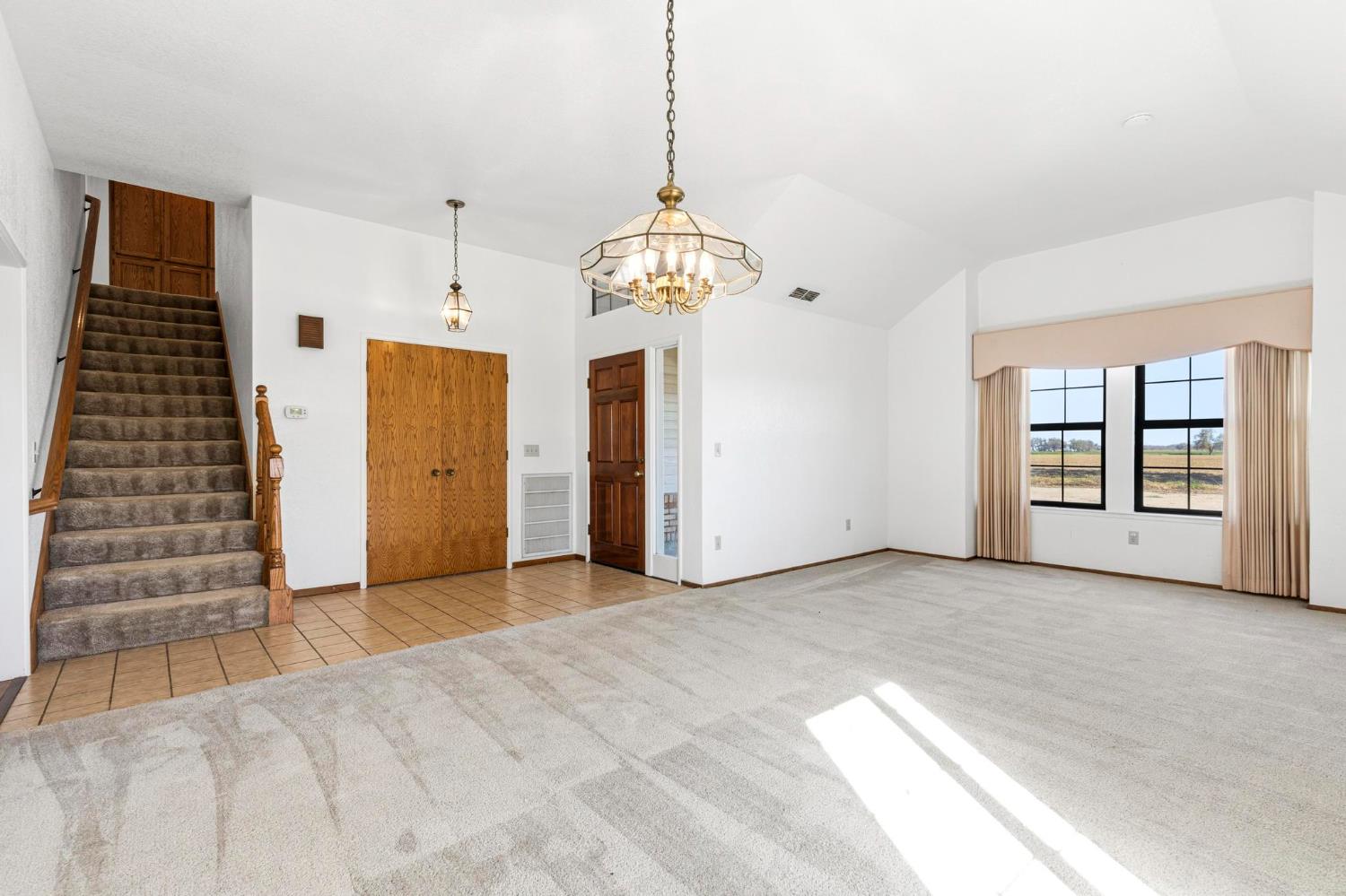 8711 Fruchtenicht Road Knights Landing, CA 95645 - Photo 10 of 44 a view of an empty room with window and chandelier