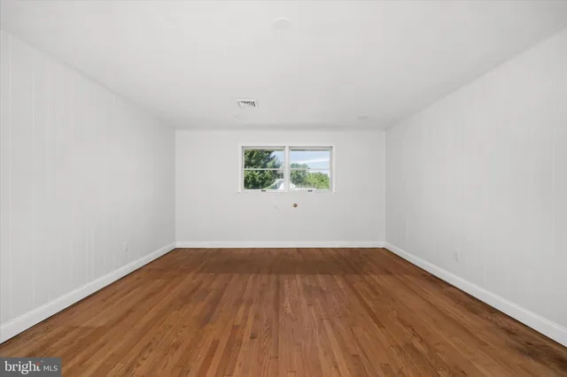 a bathroom with double sink and a mirror