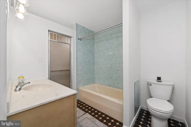 a view of a garden with lawn chairs and plants