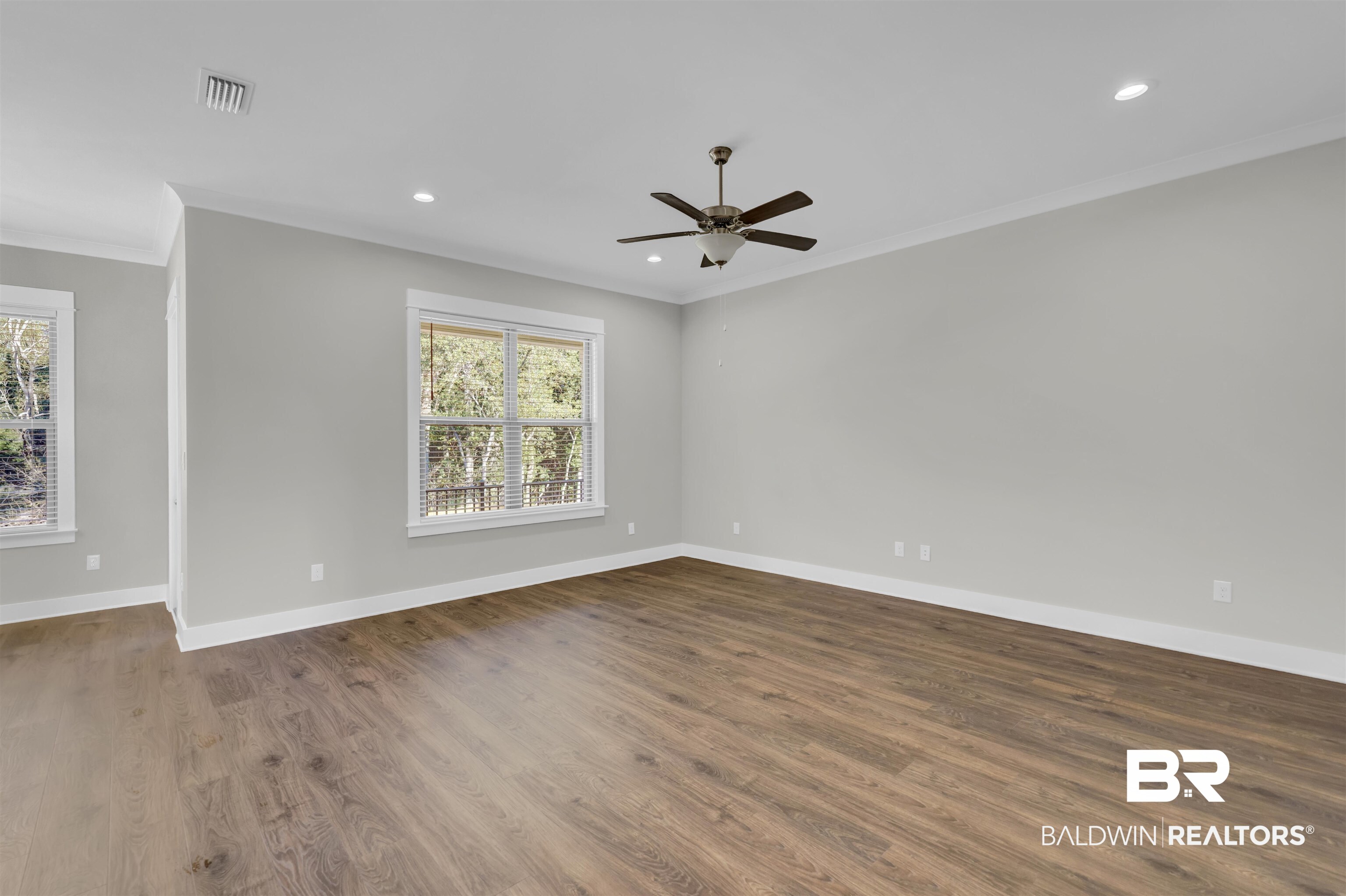 571 Morning Mist Way Fairhope, AL 36532 - Photo 15 of 47 Spare room featuring crown molding, dark wood finished floors, recessed lighting, and ceiling fan