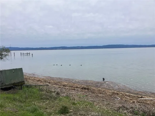 a backyard of a house with a yard and lake view