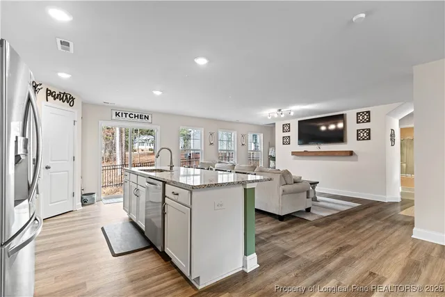 a dining room with furniture and wooden floor