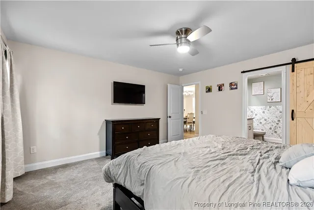 a bedroom with a bed and a flat screen television