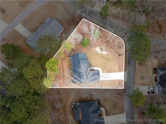 an aerial view of a house with a yard
