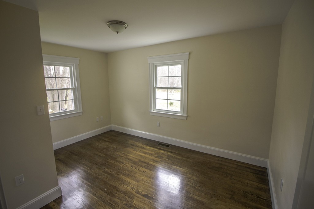 55 Argilla Road Ipswich, MA 01938 - Photo 14 of 26 an empty room with wooden floor and windows