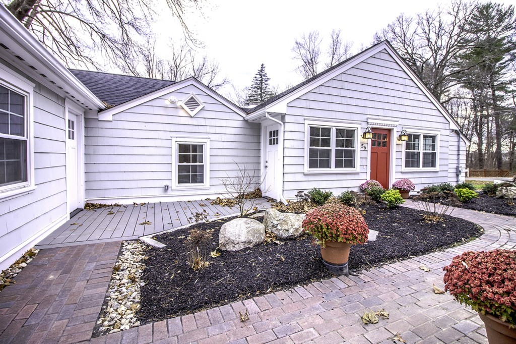 55 Argilla Road Ipswich, MA 01938 - Photo 2 of 26 a front view of a house with a yard and seating space