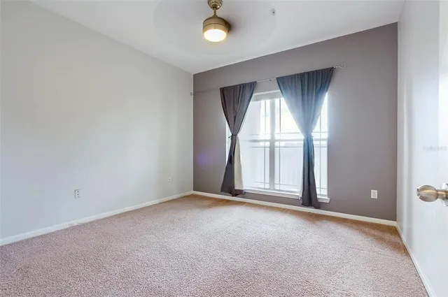 an empty room with windows and closet