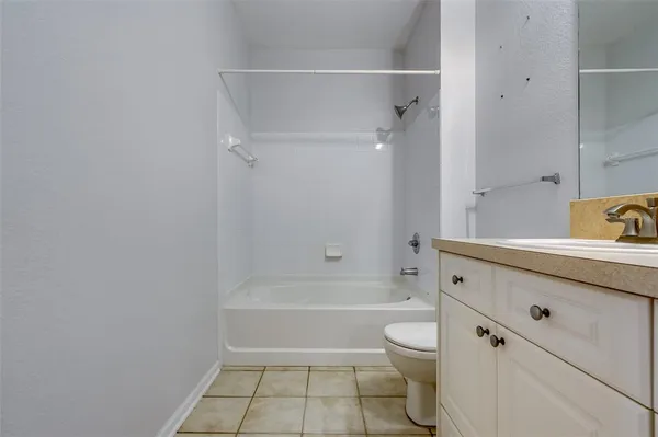 a bathroom with a granite countertop toilet a sink and bathtub