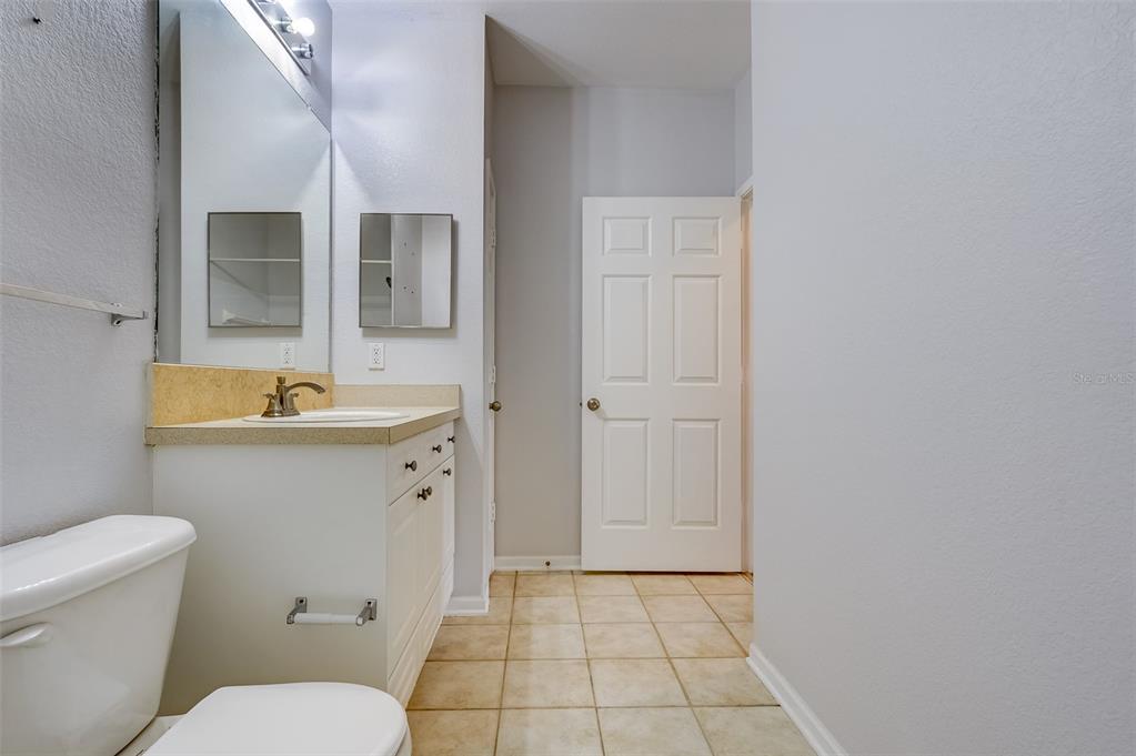 1216 South Missouri Avenue, Unit 311 Clearwater, FL 33756 - Photo 28 of 32 a bathroom with a sink a toilet and shower