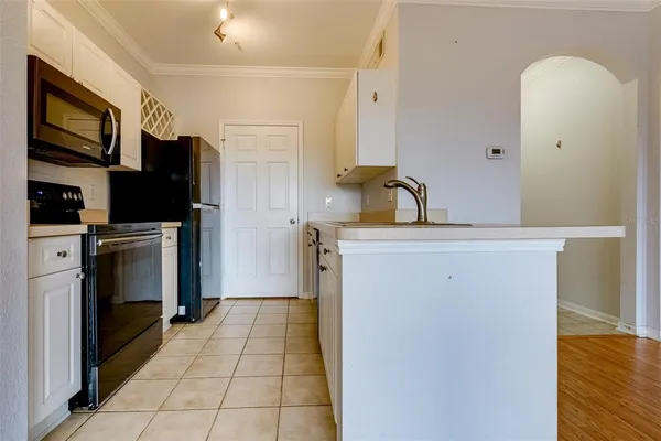 a kitchen with a refrigerator sink and cabinets