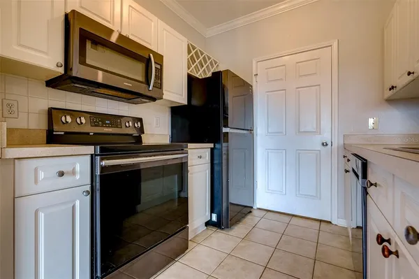 a kitchen with cabinets and steel stainless steel appliances