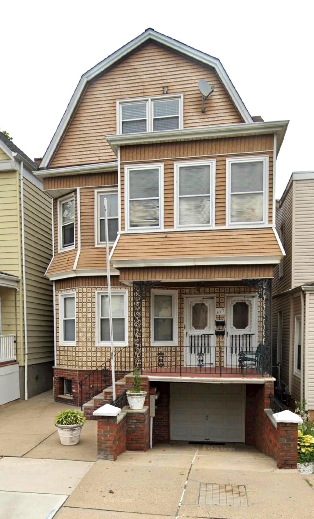 413 Davis Avenue, Unit 2 Harrison, NJ 07029 - Photo 14 of 14 a front view of a house with a garden