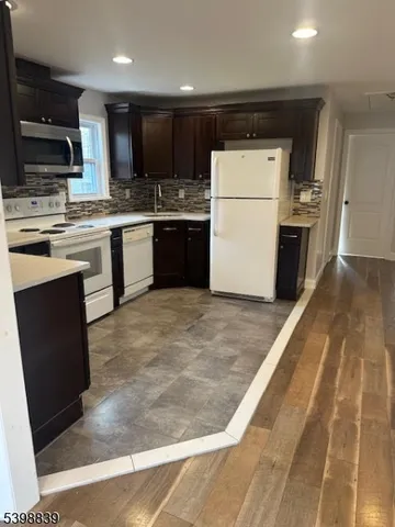 a kitchen with a refrigerator sink and microwave