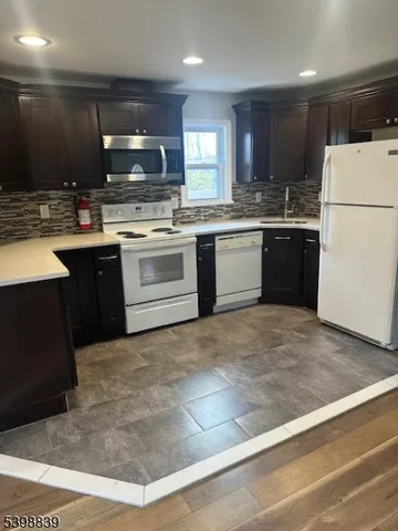 a kitchen with a sink stainless steel appliances and cabinets